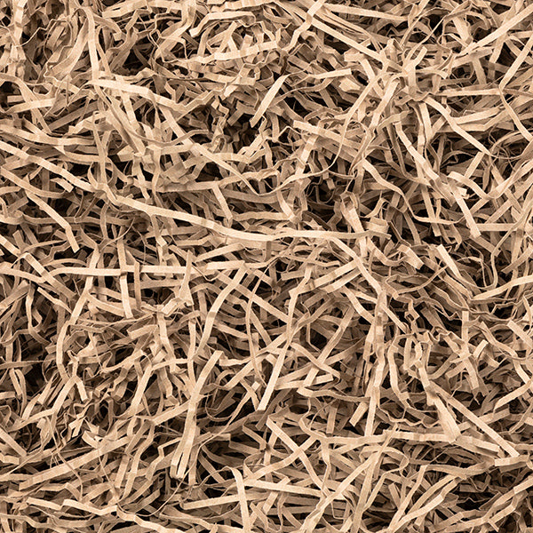 Close-up of natural shredded kraft paper packaging. Eco-friendly and biodegradable, this protective filling is ideal for securing luxury items while enhancing the unboxing experience.