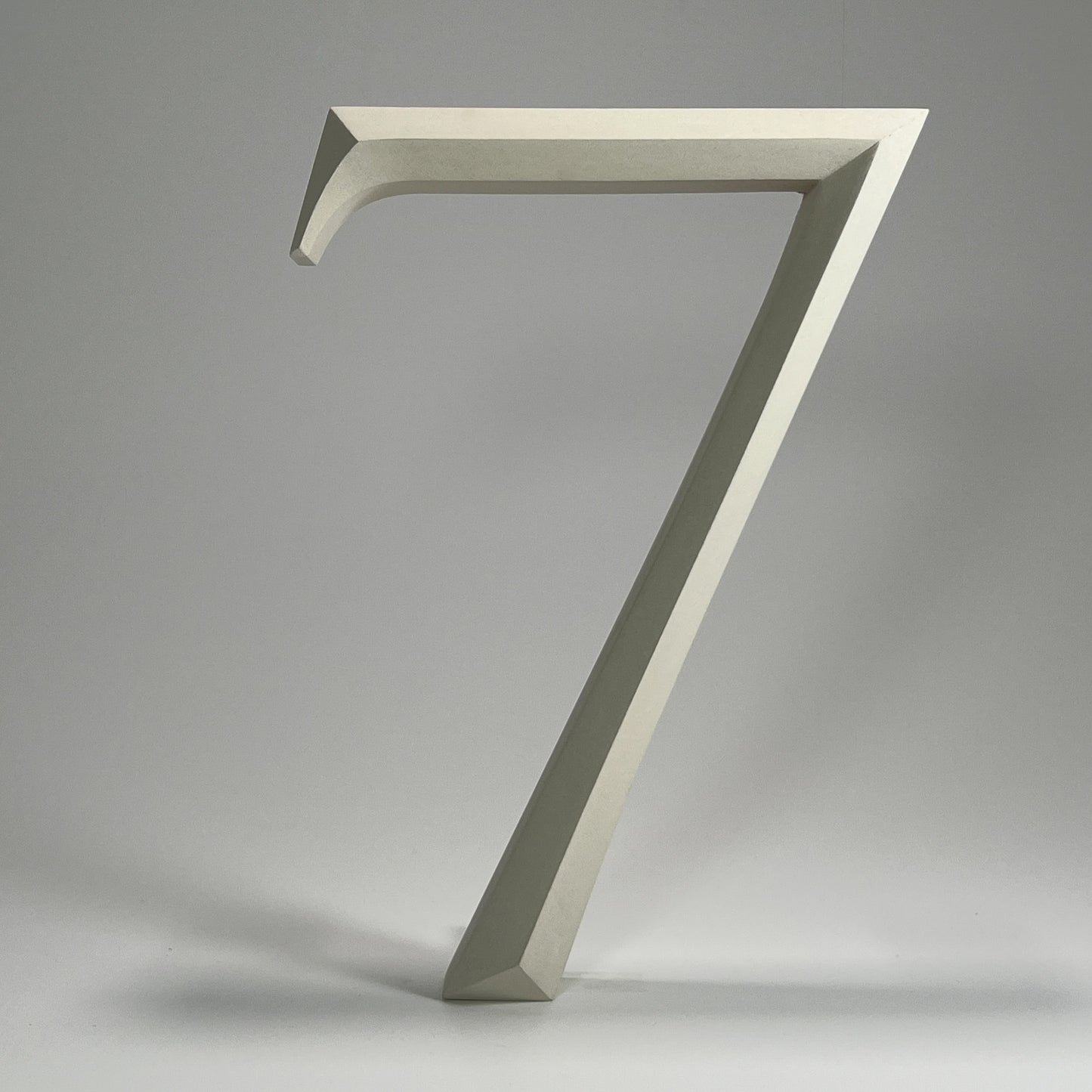 Elegant floating prismatic house number ‘7’, suitable for luxury homes and timeless architectural designs.