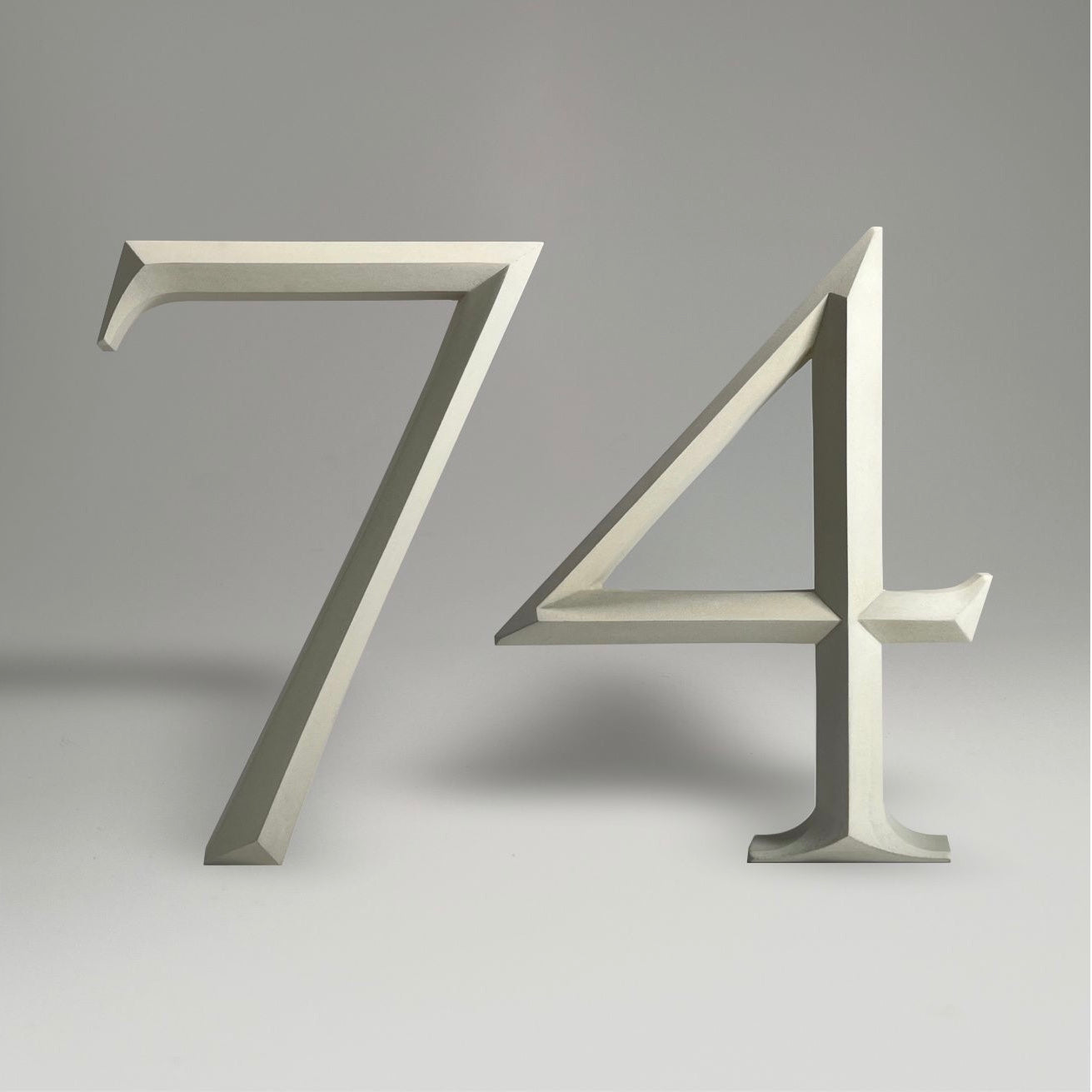 Elegant floating prismatic house number ‘74’, suitable for luxury homes and timeless architectural designs.