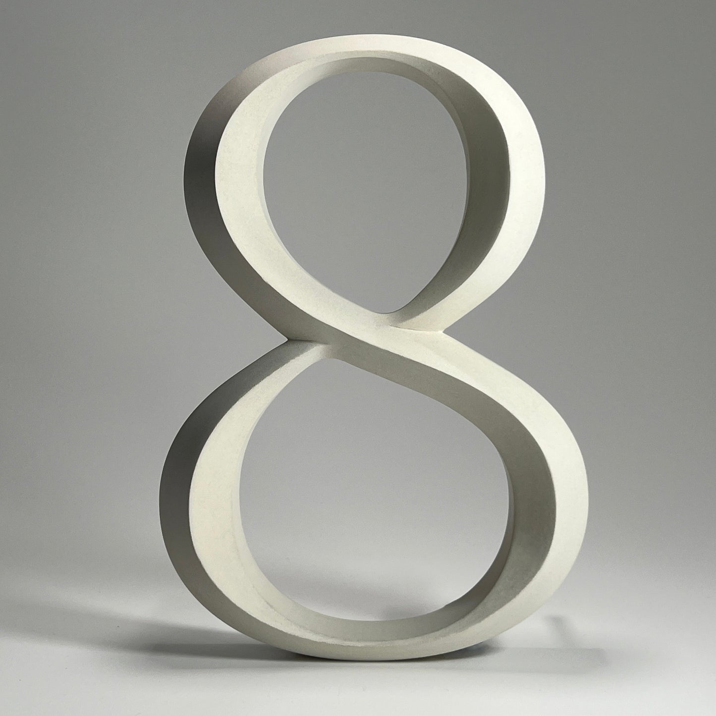 Elegant floating prismatic house number ‘8’, suitable for luxury homes and timeless architectural designs.