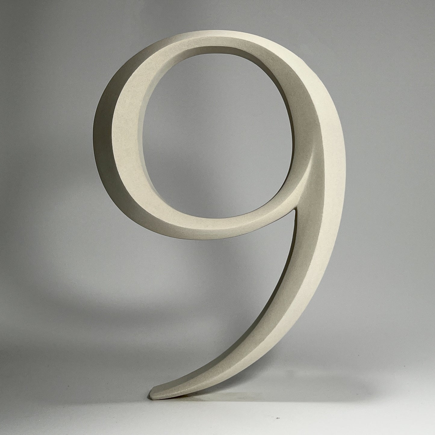 Elegant floating prismatic house number ‘9’, suitable for luxury homes and timeless architectural designs.